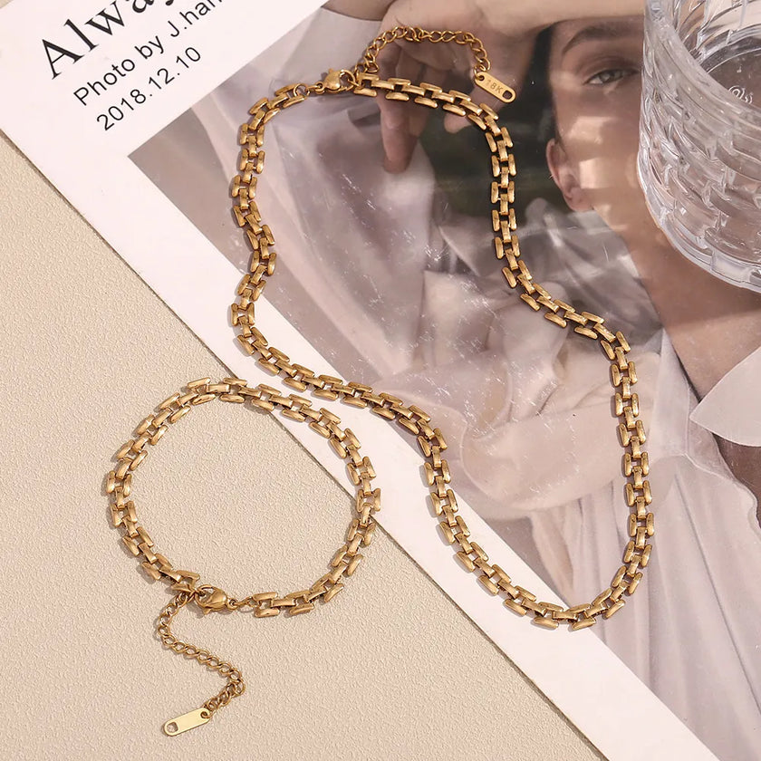Gold chain necklace on a magazine with a blurred background