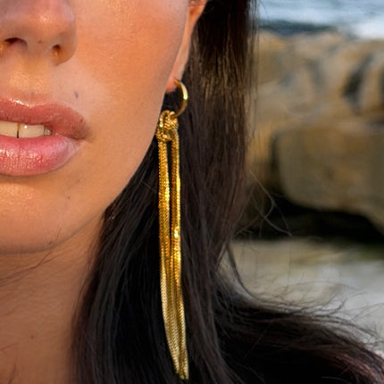 Long gold plated liquid tassel drop earrings in motion — Bye Bye Baby