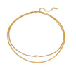 Gold necklace with a pearl pendant on a white background