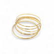 Set of 7 smooth gold plated stacking bangles worn together — Bye Bye Baby